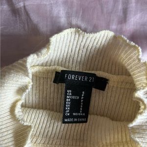 beige frilly turtle neck